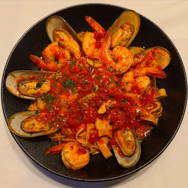 Ancona Bistro's seafood pasta with mussels, shrimp, and tagliatelle in a rich red sauce.